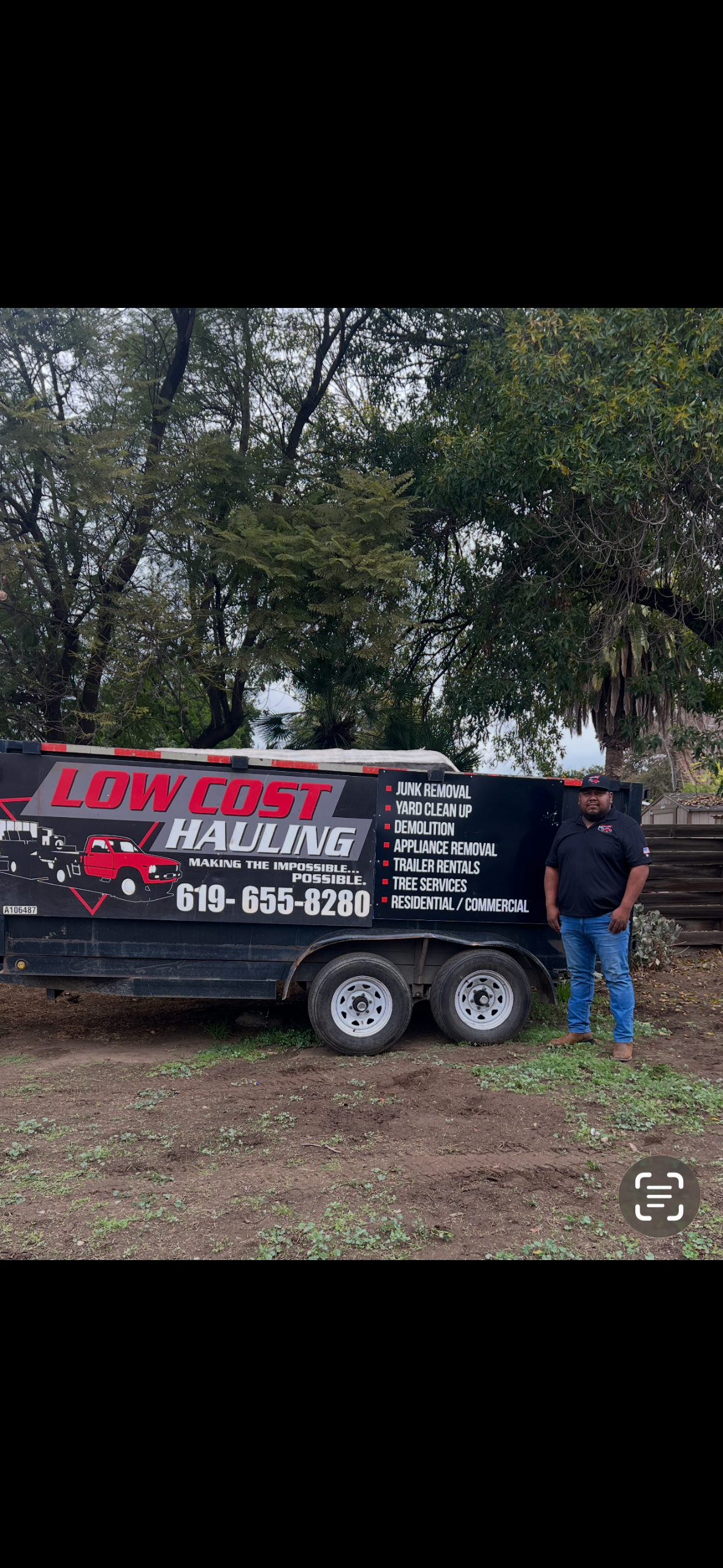 Juan Aragon with hauling trailer on job site